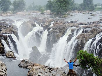 Scenic view of waterfall against rocks