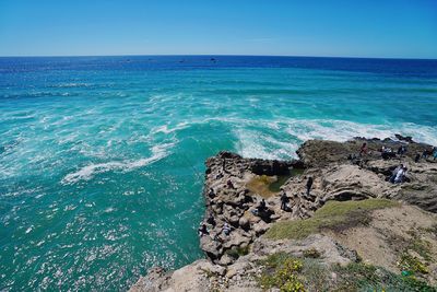 Scenic view of sea against clear blue sky