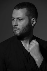 Close-up man looking away against gray background