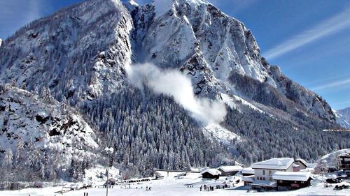 Scenic view of snow covered mountains against sky