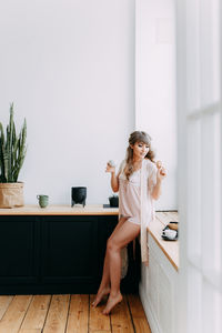 Woman sitting on floor at home