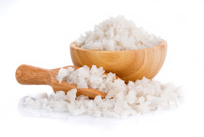 Close-up of sea salt against white background