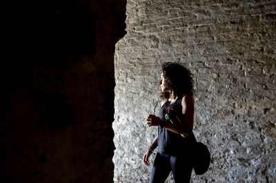 Profile view of a mixed race woman drinking mate.