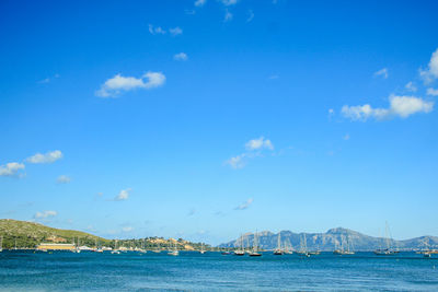 Scenic view of bay against blue sky
