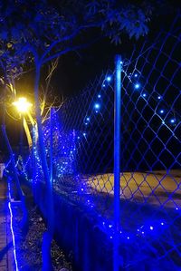 Low angle view of illuminated lights at night