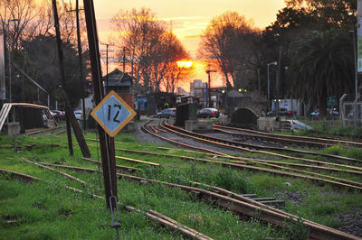 View of railroad tracks by road against sky