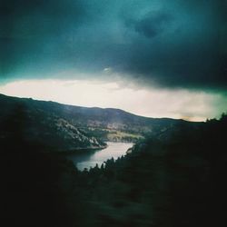 Scenic view of mountains against cloudy sky