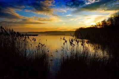 Scenic view of lake against sky during sunset