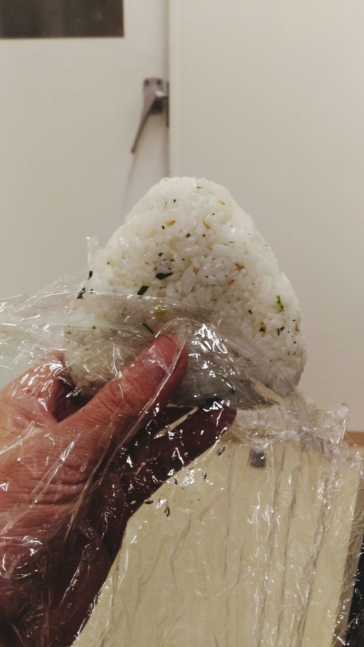 CLOSE-UP OF HAND HOLDING ICE CREAM IN PLATE