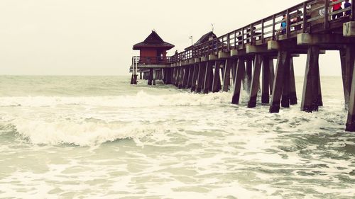 Pier over sea against clear sky