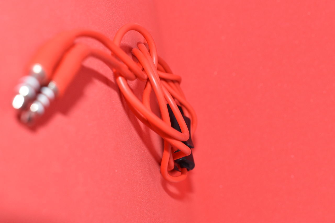 CLOSE-UP OF EYEGLASSES ON RED TABLE