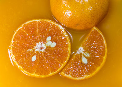 Close-up of orange slices floating in orange juice