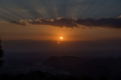 Scenic view of silhouette mountains against sky during sunset