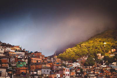 Houses in city against sky