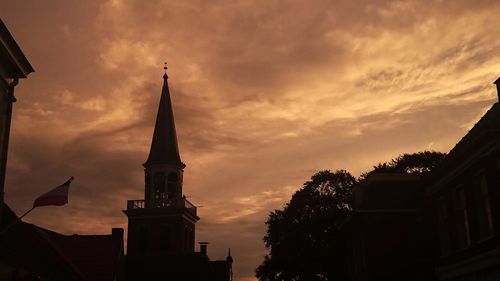 Low angle view of building against cloudy sky