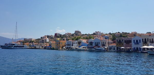 View of townscape by sea against clear sky