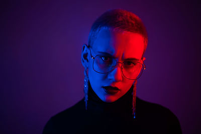 Portrait of young man against blue background