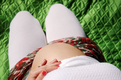 Close-up of pregnant woman holding belly