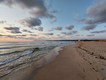 Scenic view of beach against sky during sunset