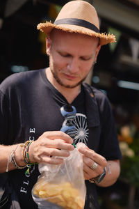 Portrait of woman holding hat