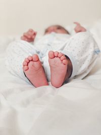 Close-up of baby sleeping on bed