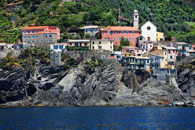 Buildings on mountain by sea at cinque terre
