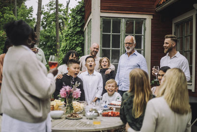 Cheerful multi-generation family screaming while celebrating birthday