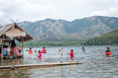 Group of people in front of mountains against sky