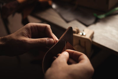 Tanner sews with threads makes leather purse. diy instruction. eco production, entrepreneur.