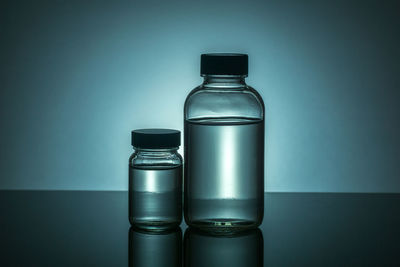 Close-up of bottles over white background