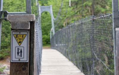 Information sign on bridge at forest