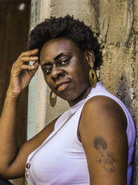 Portrait of smiling woman with tattoo looking away