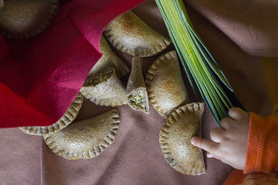 Close-up high angle view of hand touching food