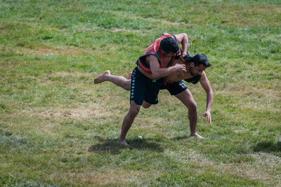 Couple kissing on field