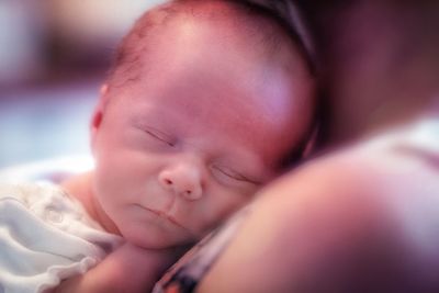 Portrait of cute baby sleeping on bed