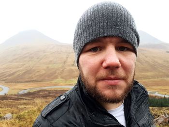 Close-up portrait of man wearing knit hat