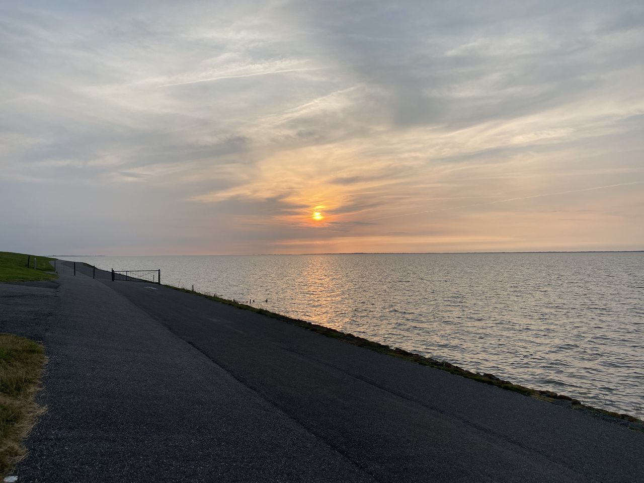 SCENIC VIEW OF BEACH AGAINST SKY DURING SUNSET