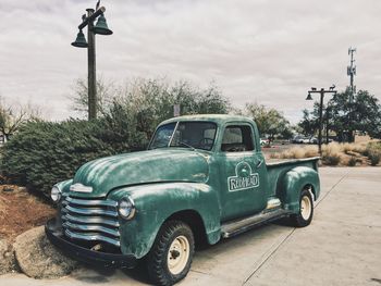 Vintage car on street against sky