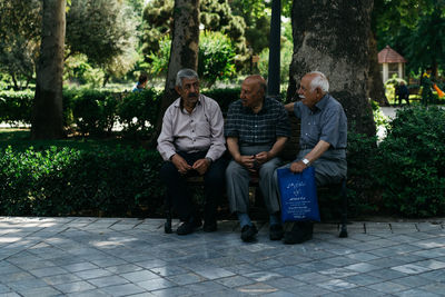 Man sitting on bench in park