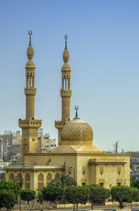 Low angle view of building against clear blue sky