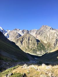 Scenic view of snowcapped mountains against clear blue sky