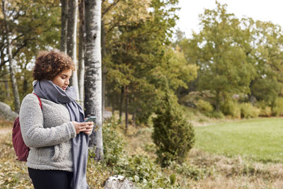 Woman using smart phone on walk