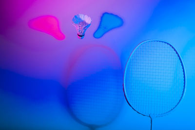 Close-up of pink umbrella against blue background