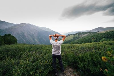 Full length of man standing on mountain against sky