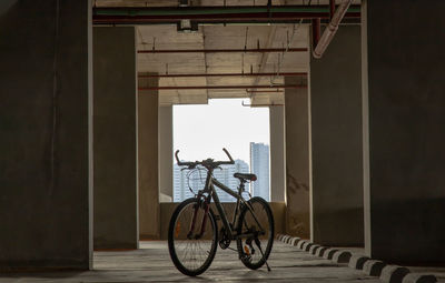 Bicycle parked against wall in building