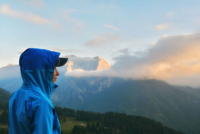 Man in mountains against blue sky