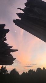 Low angle view of silhouette trees against sky during sunset