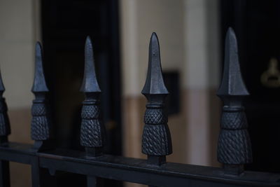 Close-up of metal railing against building