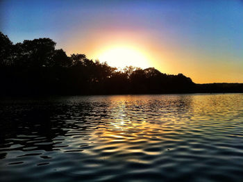 Scenic view of lake at sunset