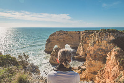 Woman on beach against sky